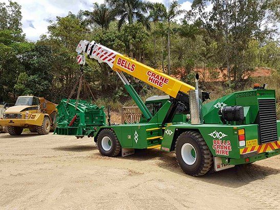 Crane Truck Lifting an Object — Bell's Carrying & Crane Hire Service Pty Ltd in Bungalow, QLD