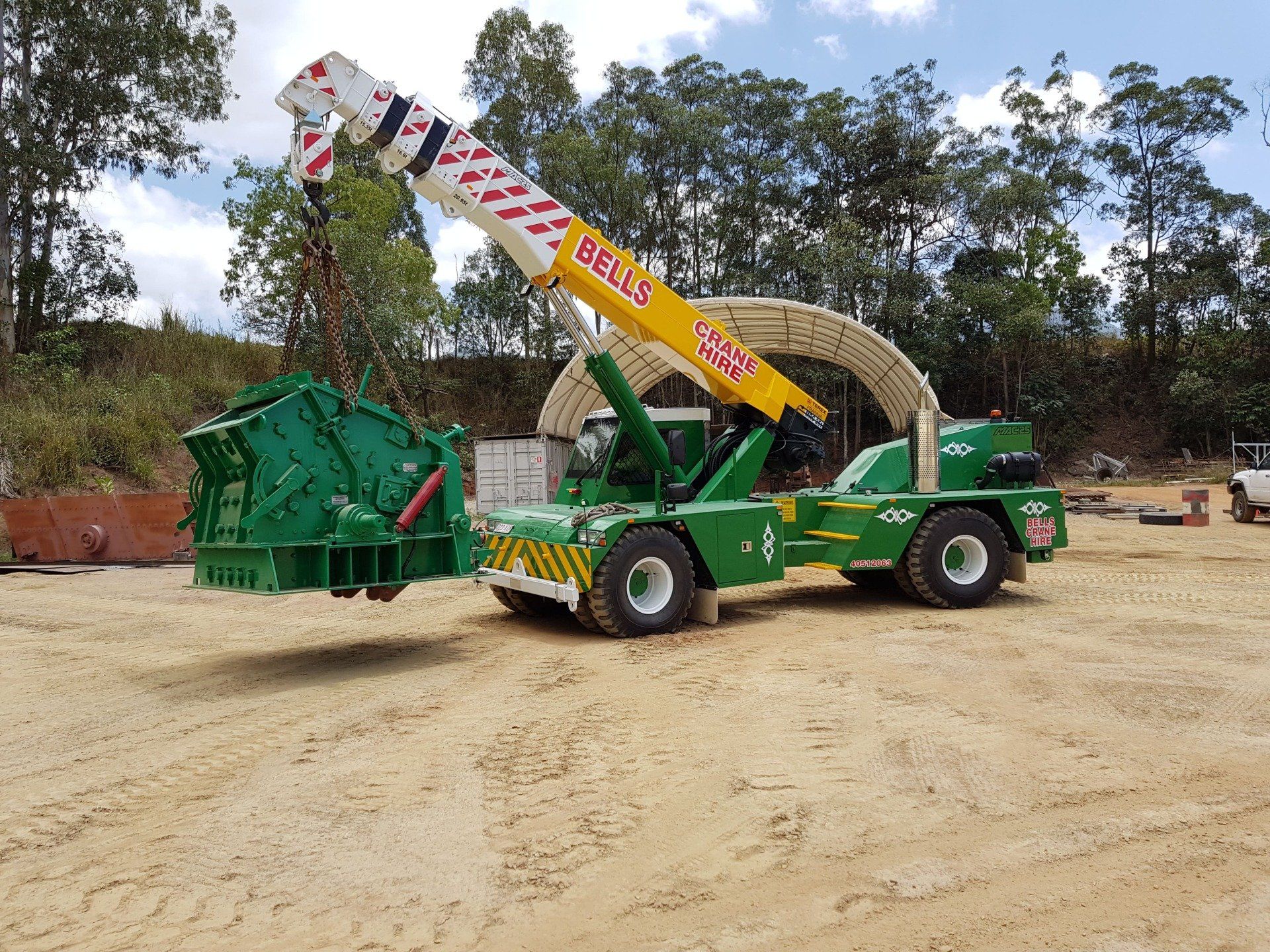 Crane Lifting an Machine — Bell's Carrying & Crane Hire Service Pty Ltd in Bungalow, QLD