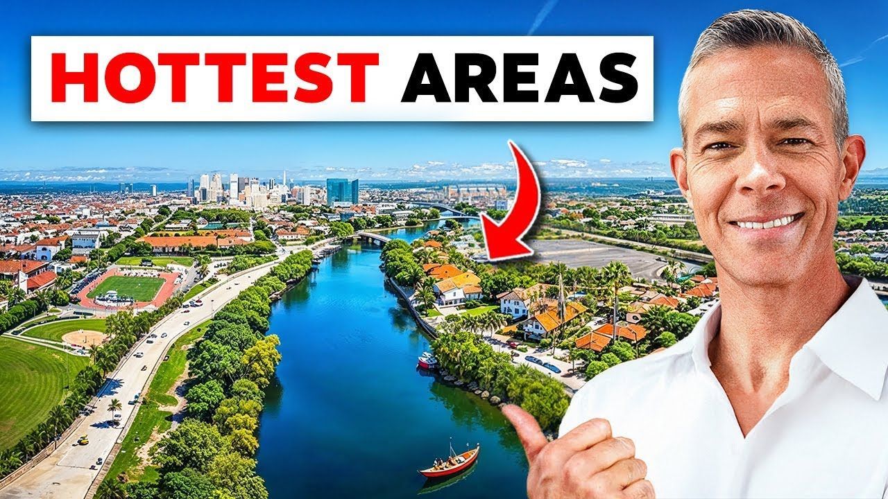 Man points to a scenic view of a river and city, with 