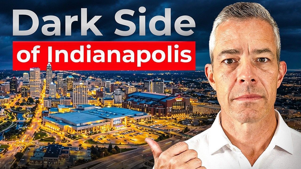 A man points towards the Indianapolis skyline at night. Text reads 