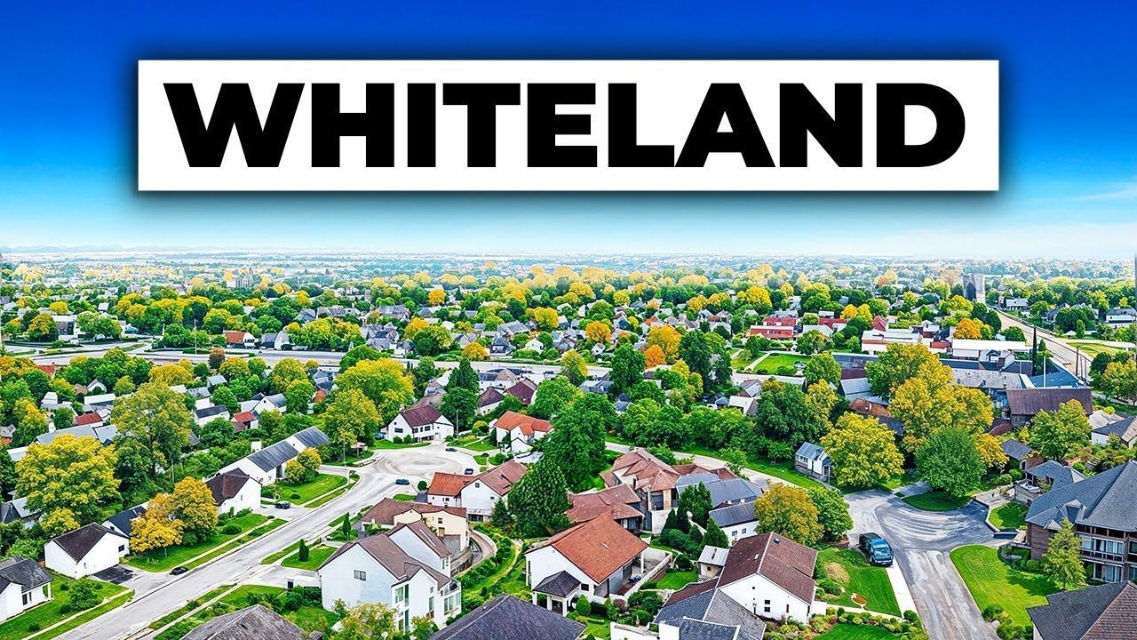 Aerial view of suburban Whiteland, Indiana with houses and trees.