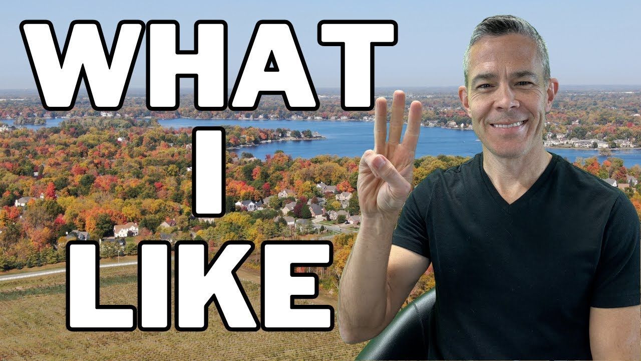 Man smiling and making a peace sign over a colorful cityscape with large text reading “WHAT I LIKE”
