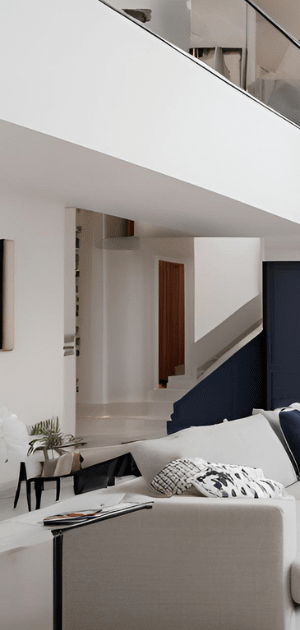 A living room with a couch and stairs in the background