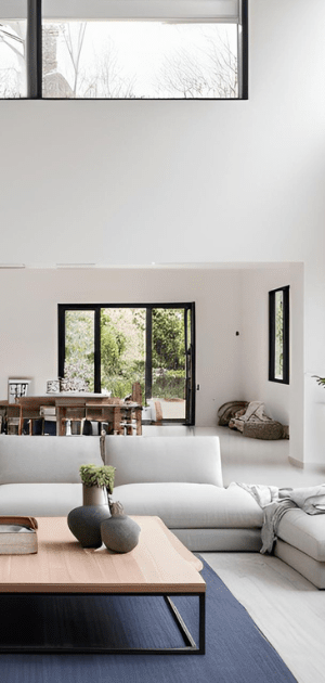 A living room with a white couch and a wooden coffee table