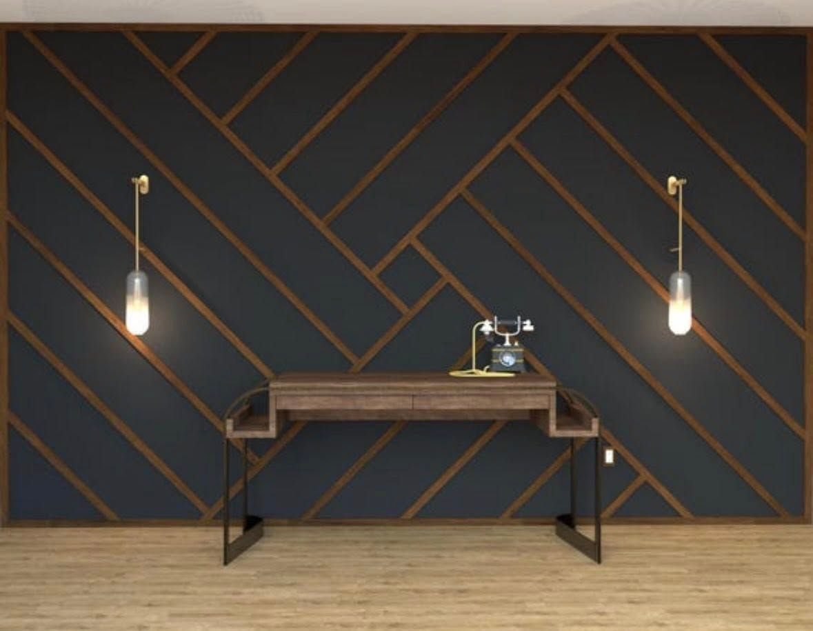 Dark blue and brown accent wall with desk and two hanging lights.