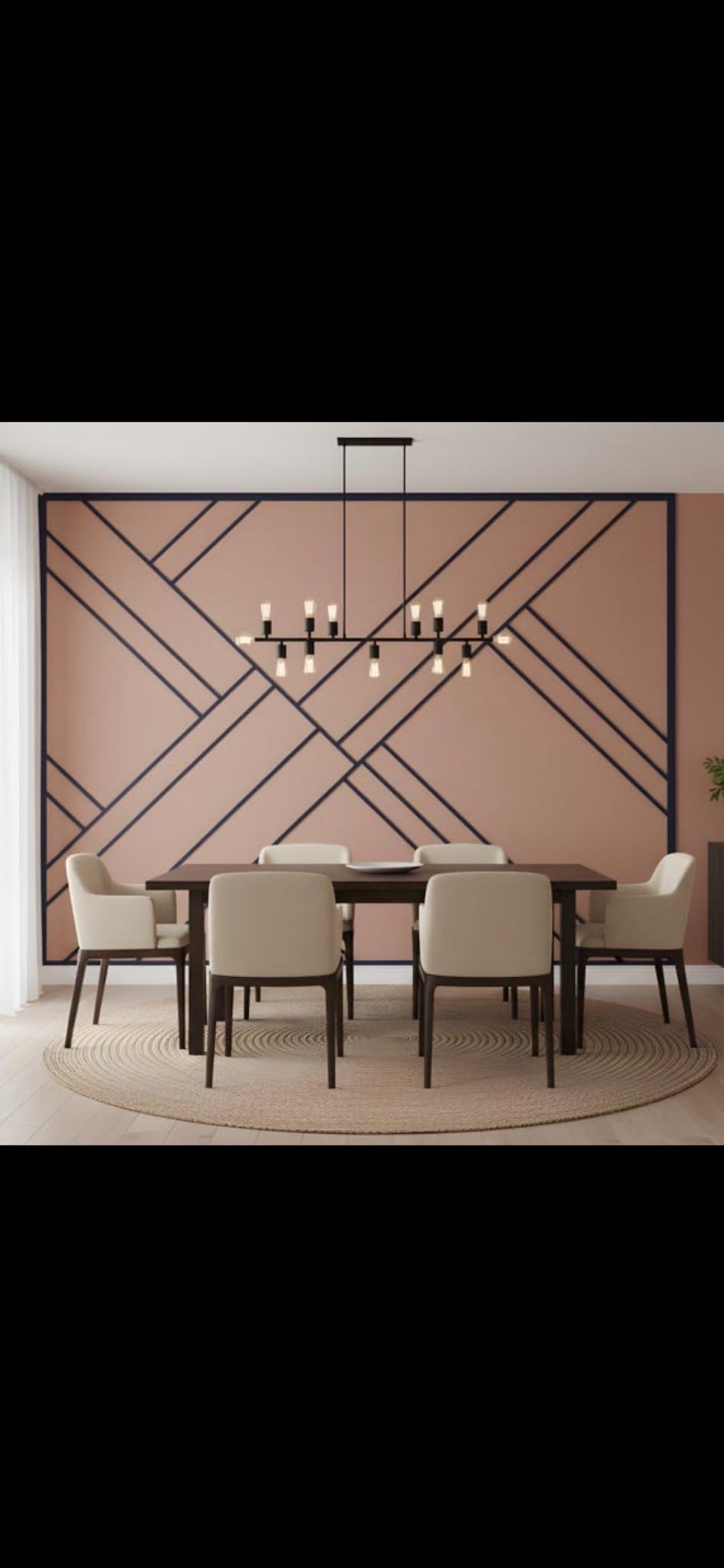 Dining room with a table, chairs, decorative wall, and chandelier.