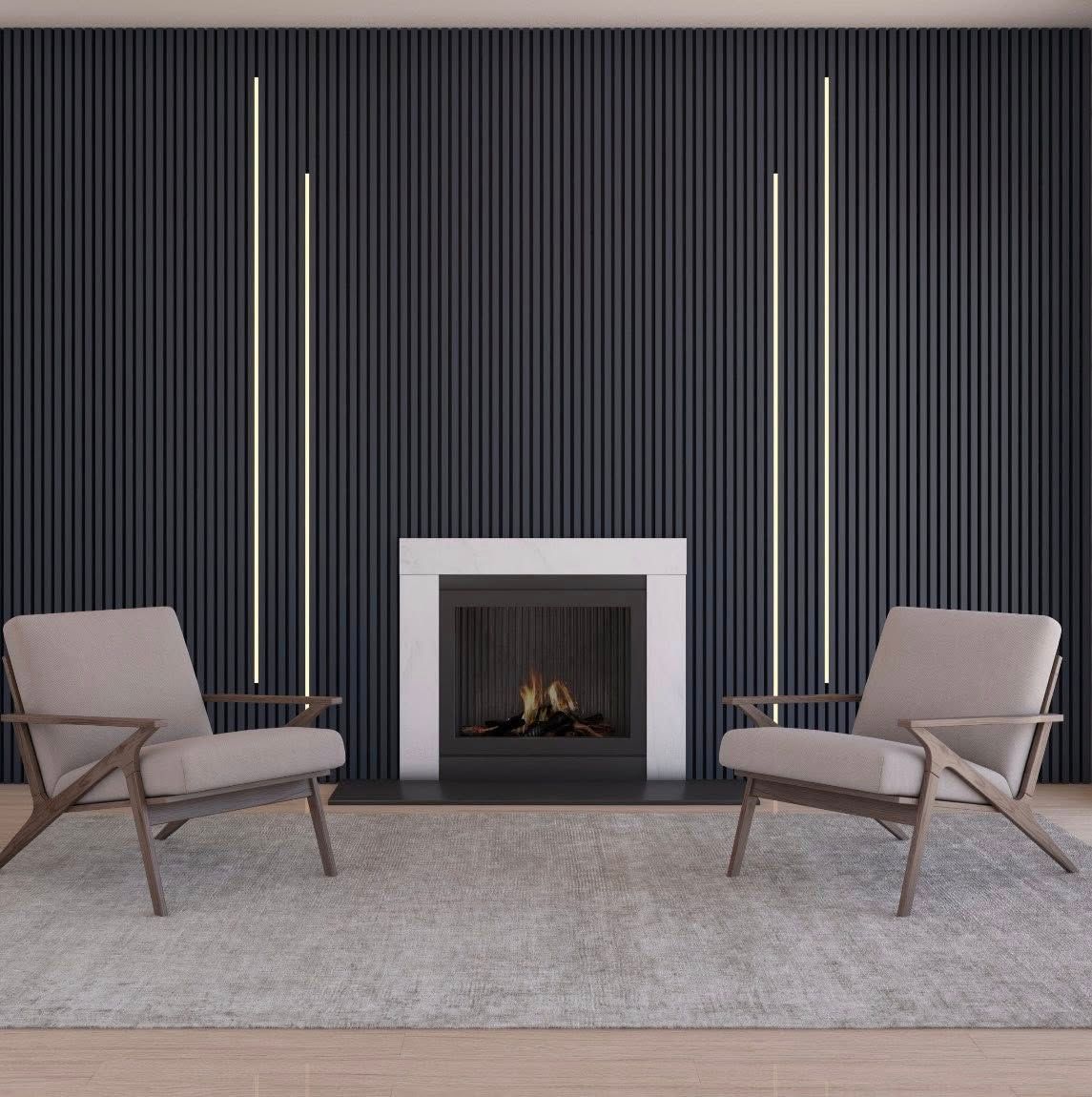 Two armchairs face a fireplace against a dark vertical-lined wall, two vertical lights, and a rug.