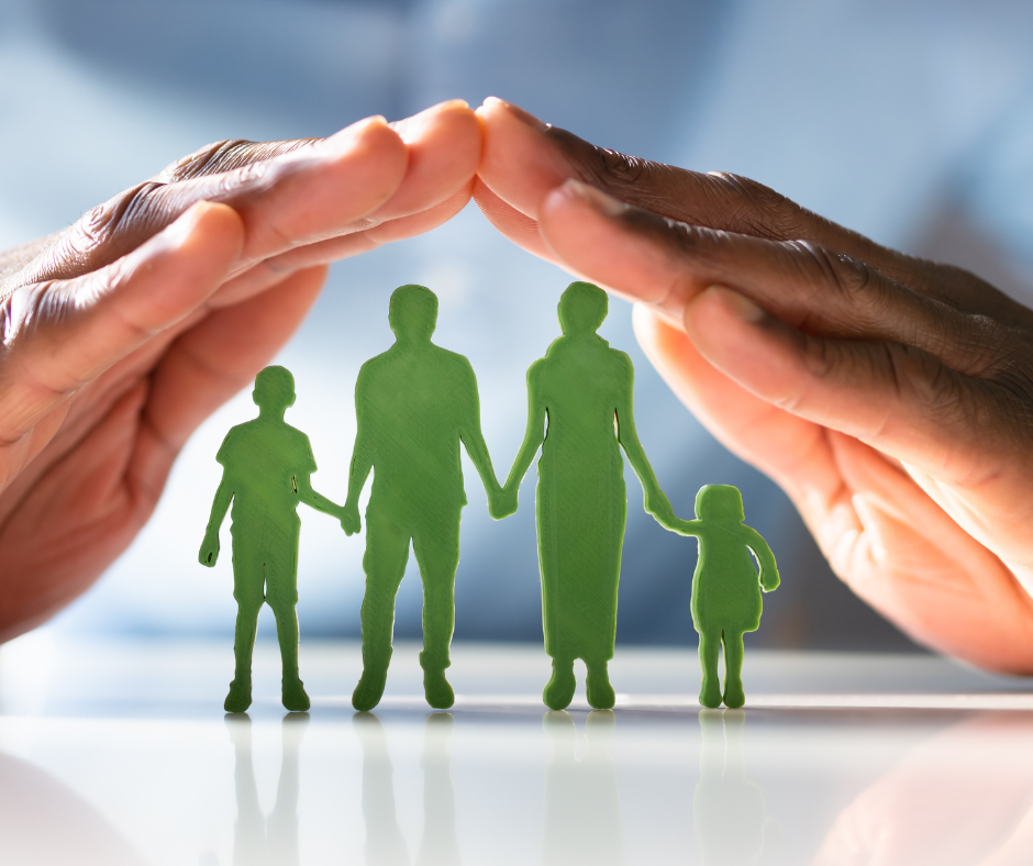 Hands forming a roof over a green silhouette of a family