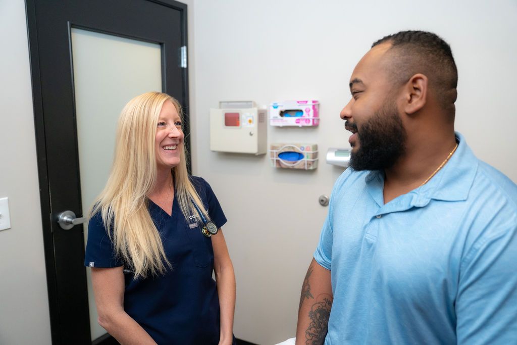 Balanced Healthcare provider physically examining a male patient