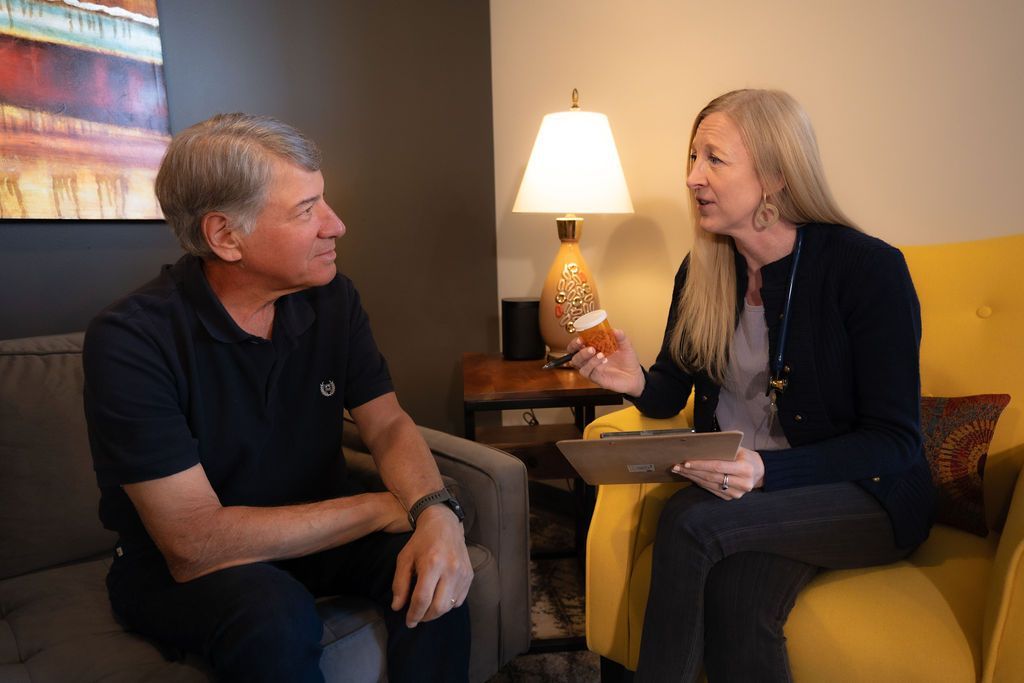 Cora Mattie speaking with a male patient during a clinic visit