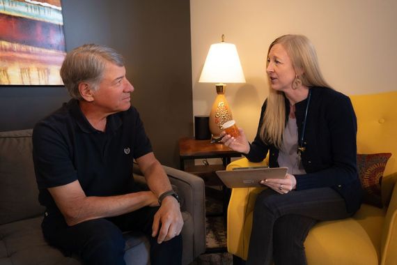 Cora Mattie speaking with a male patient during a clinic visit