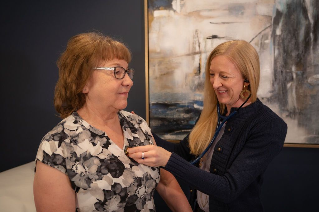 Cora Mattie assisting a patient with a stethoscope