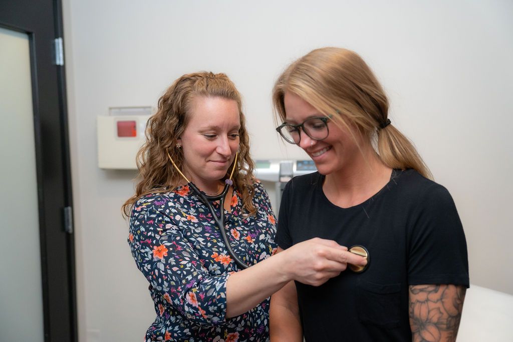 Julie Cookish of Balanced Healthcare taking patient's pulse
