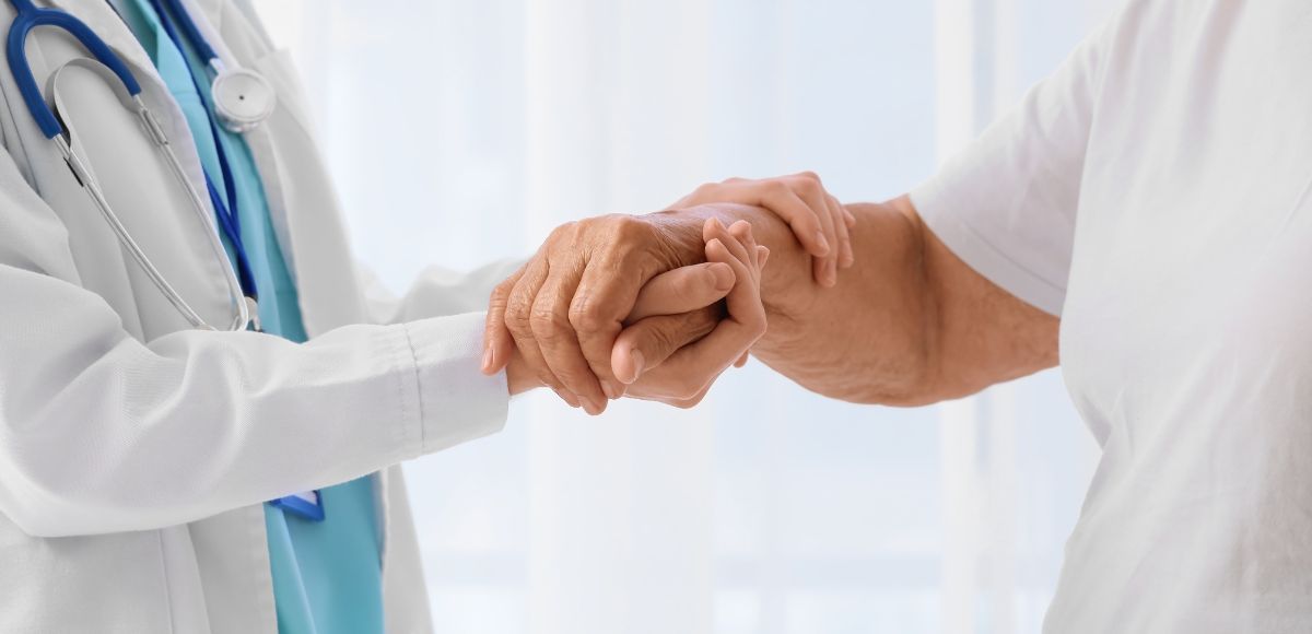 Direct Primary Care provider and patient shaking hands in a bright clinic setting