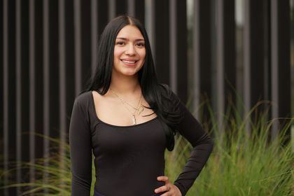 Joanna posing indoors against a light background in casual attire