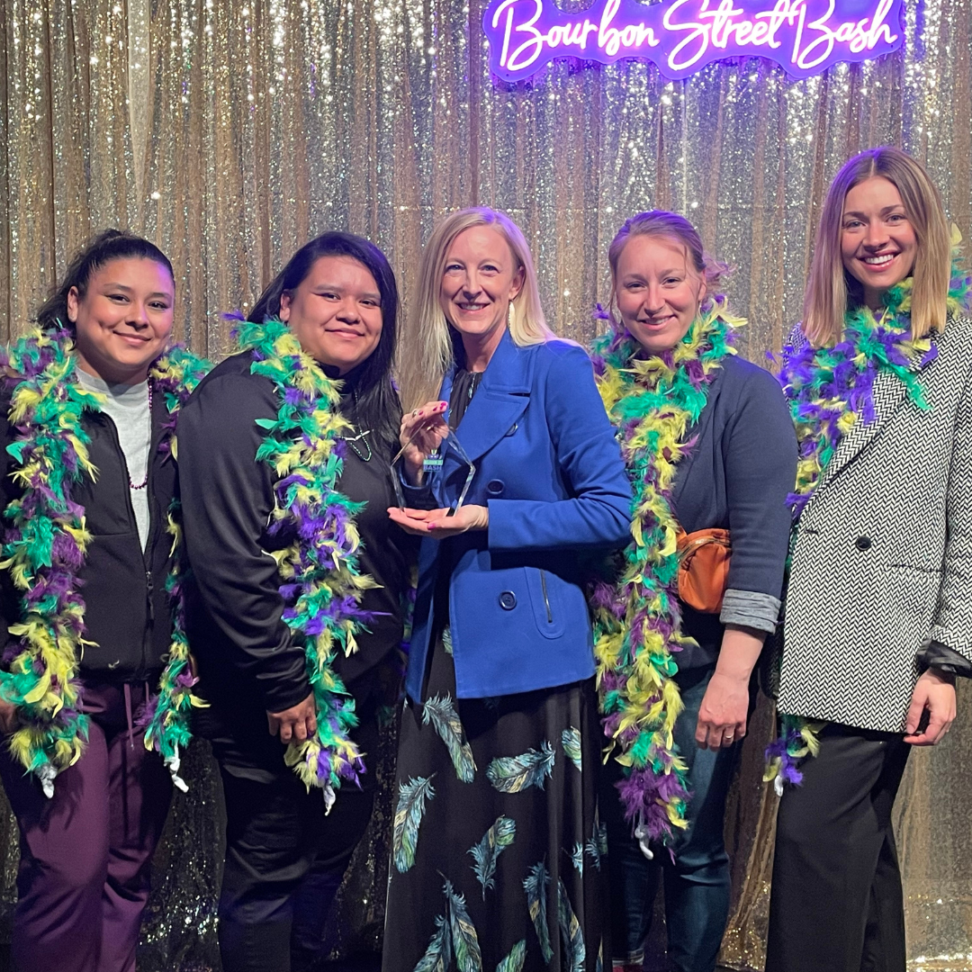 Cora Mattie and team at Balanced Healthcare receiving an award at the Bourbon St. Bash