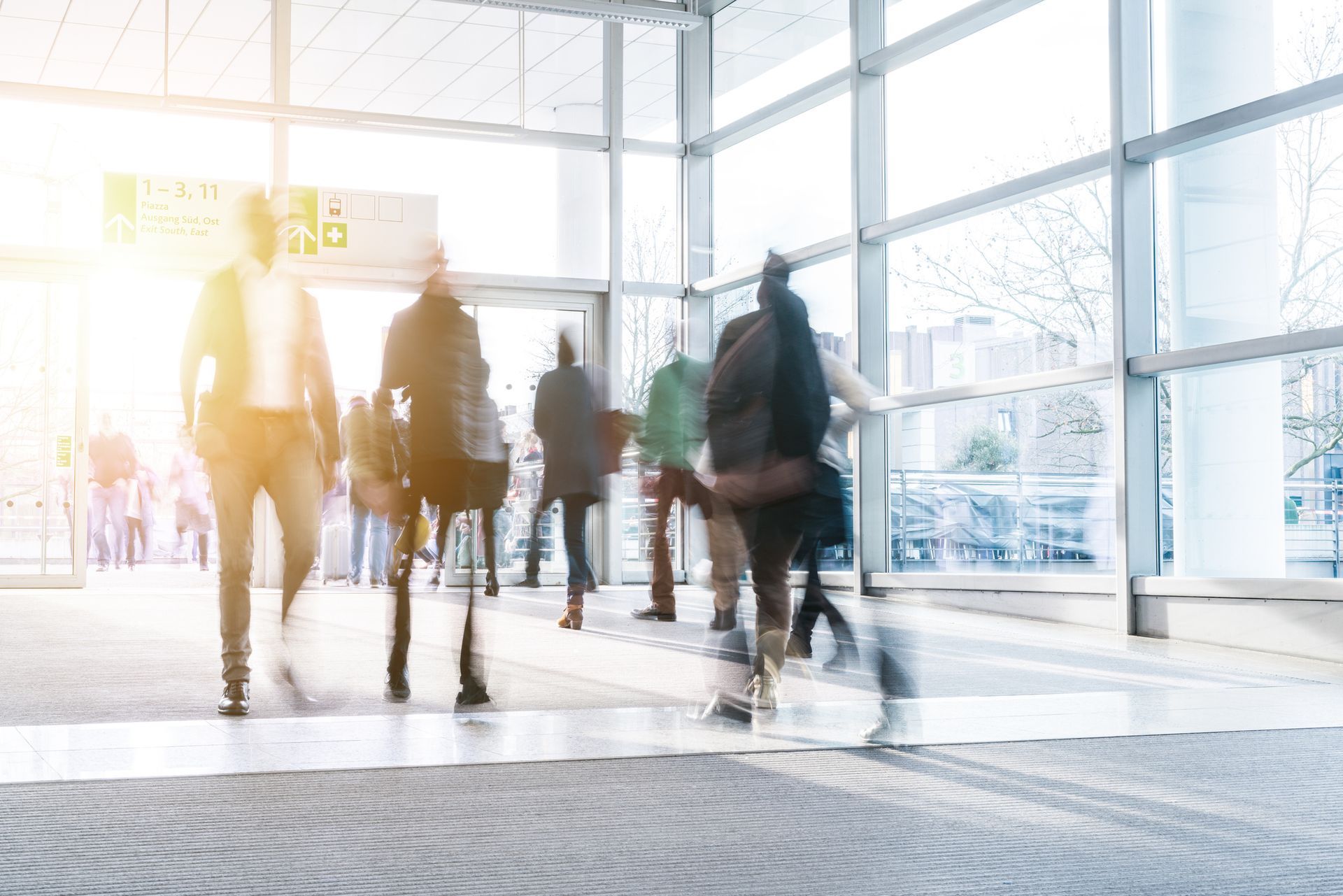 A blurry picture of a group of people walking through a building.