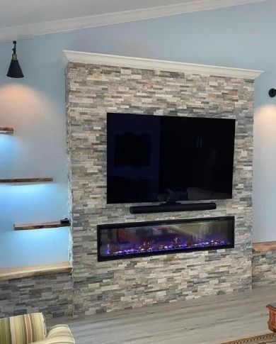 Modern living room fireplace wall with stacked stone, mounted TV, and electric fire beneath