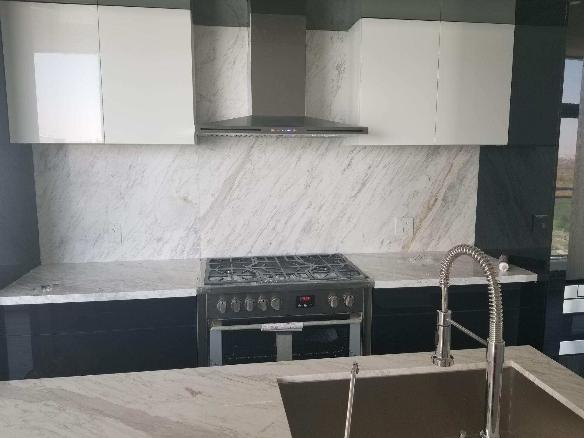 A kitchen with a stove top oven and a sink