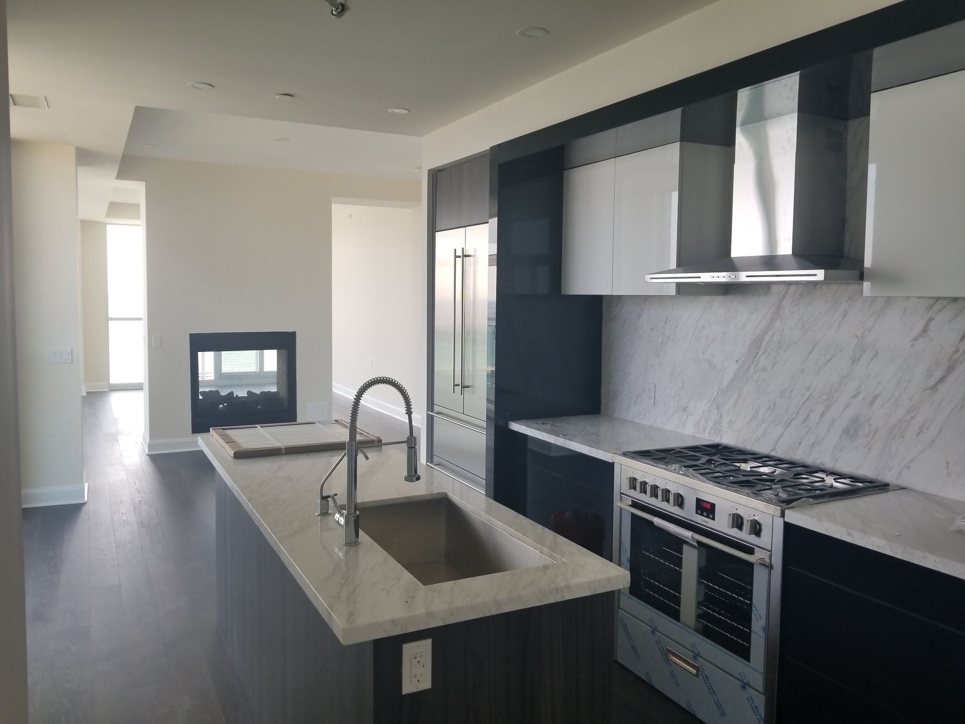 a kitchen with a stove top oven and a sink