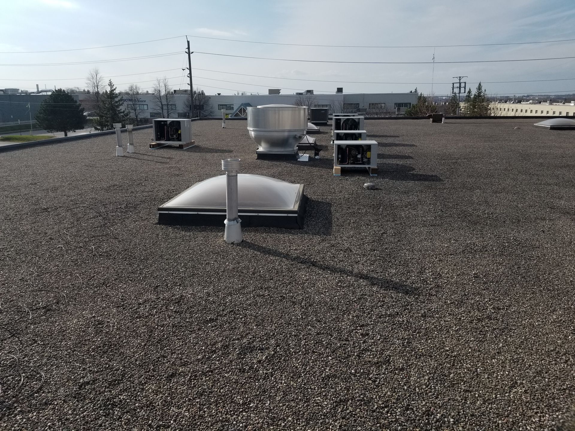 A roof with a lot of ventilation equipment on it