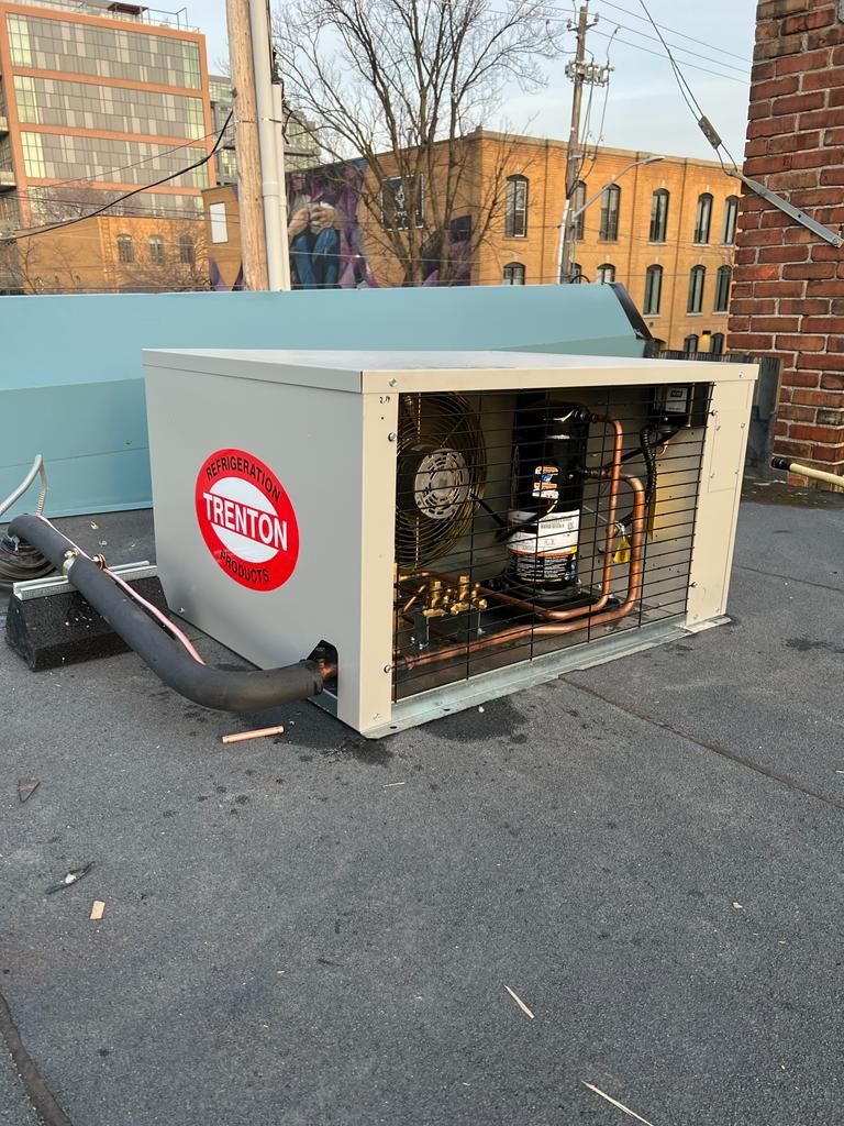 HVAC unit on a rooftop with exposed components and a 