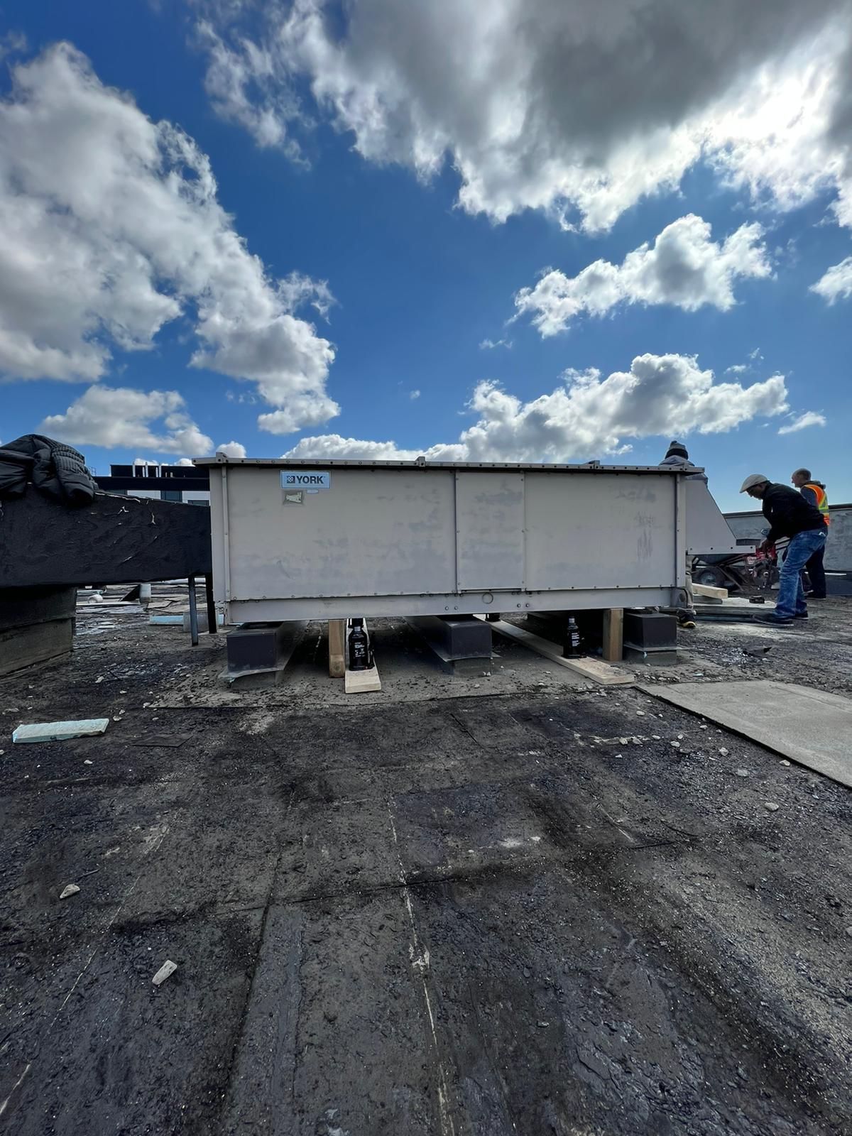 A large white box is sitting on top of a roof.