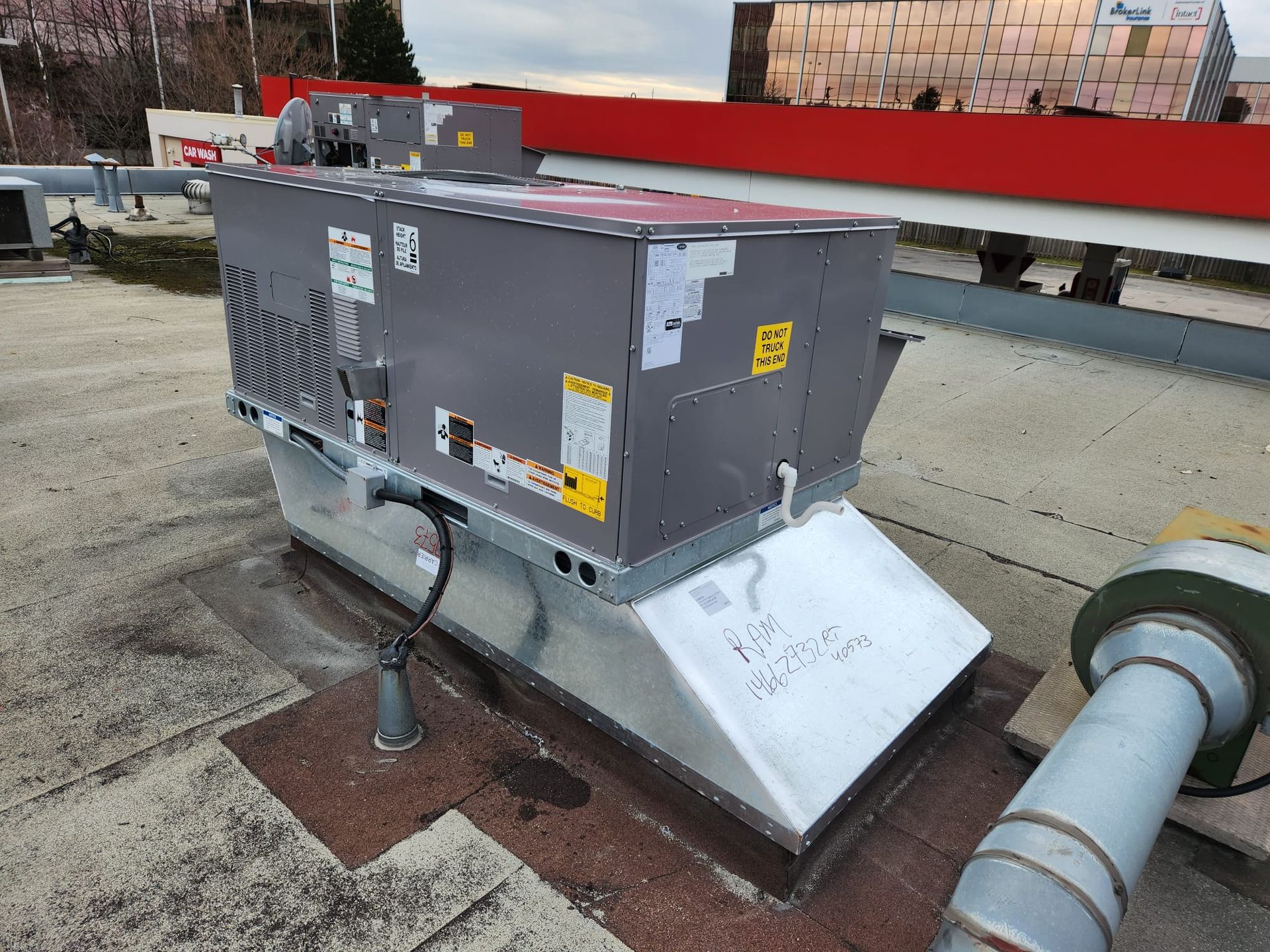 a large air conditioner is sitting on top of a roof .