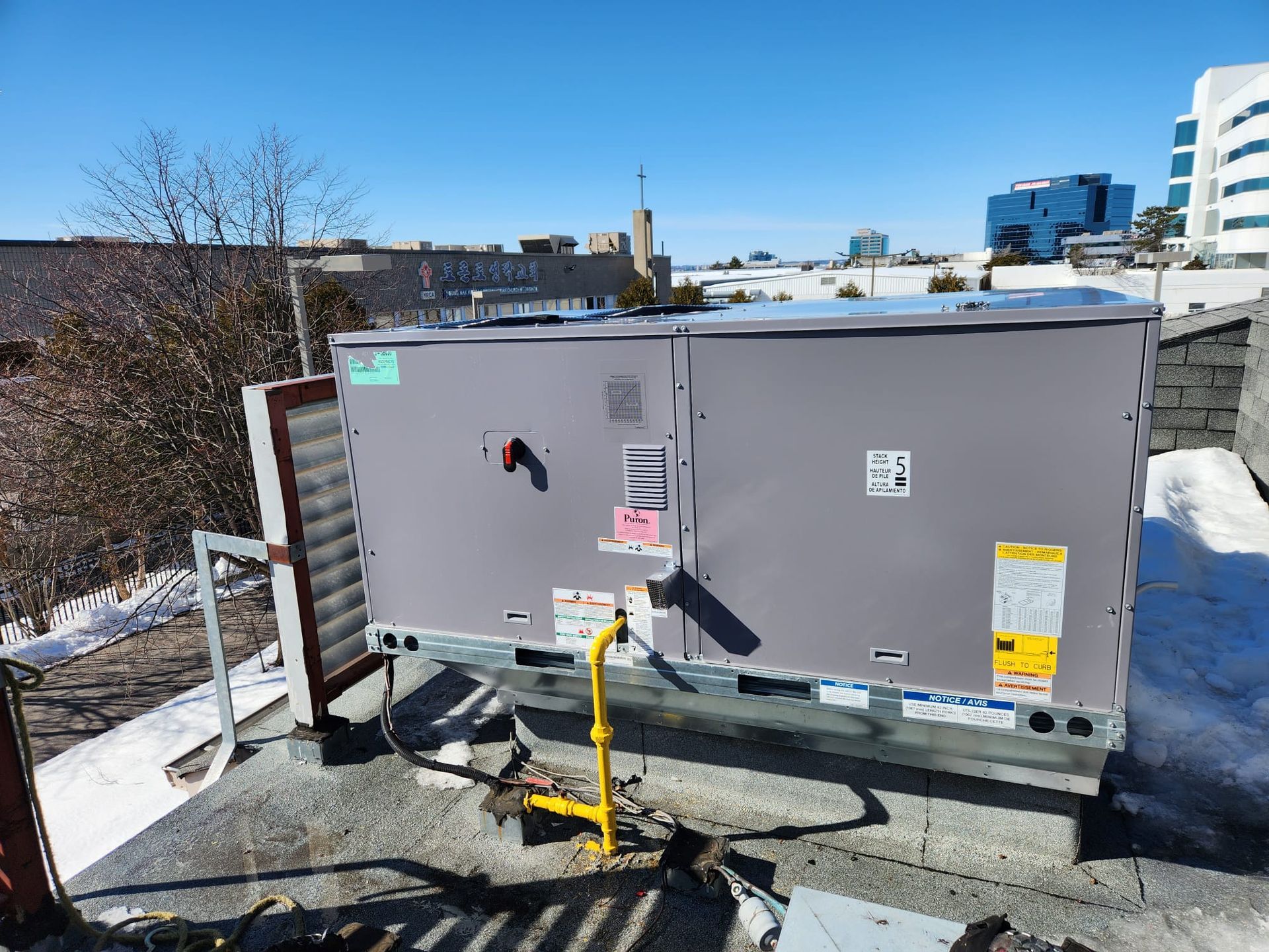 a large air conditioner is sitting on top of a roof .