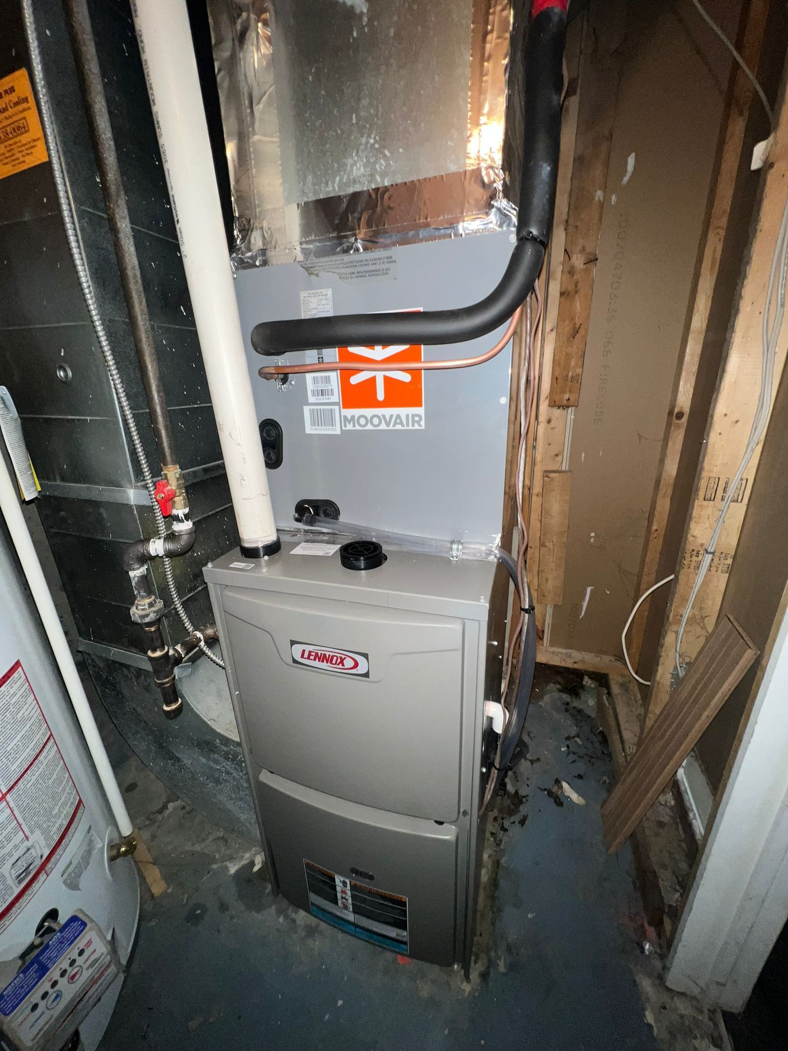Indoor HVAC furnace and air handler in a basement.