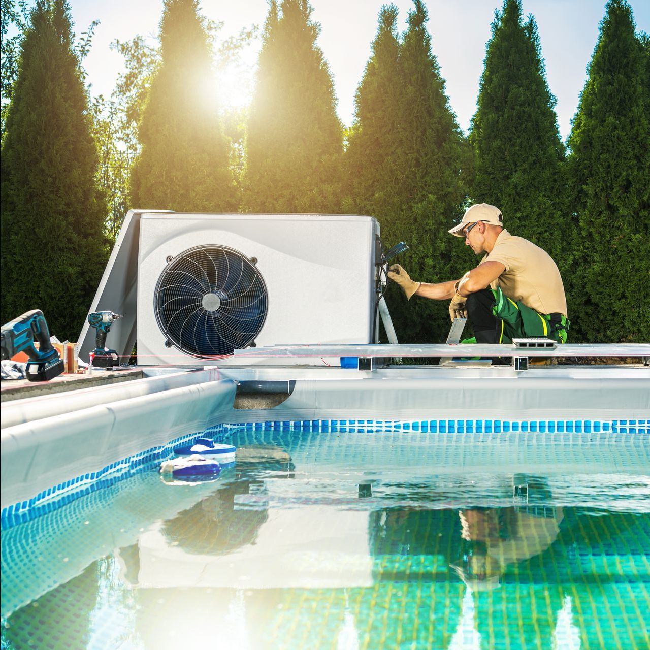 a man is working on an air conditioner on top of a swimming pool .
