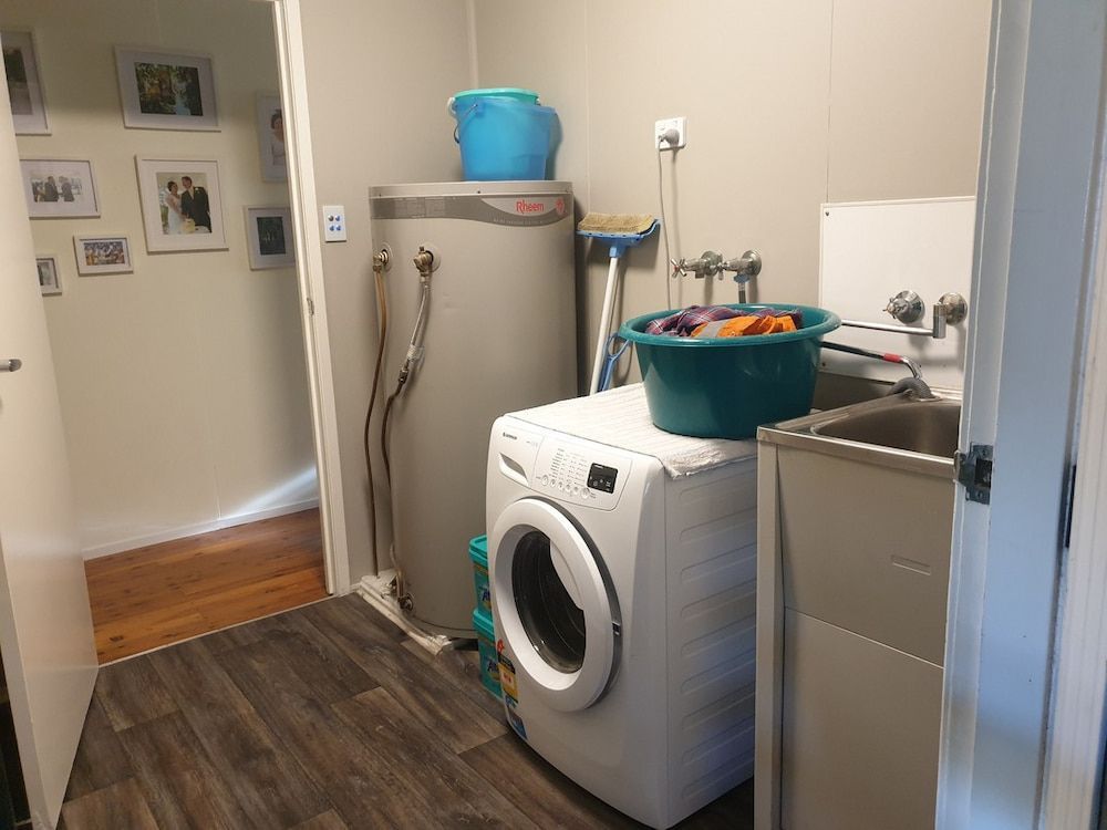 A Laundry Room With A Washer And Dryer And A Sink — Pioneer Cabinets in Paget, QLD