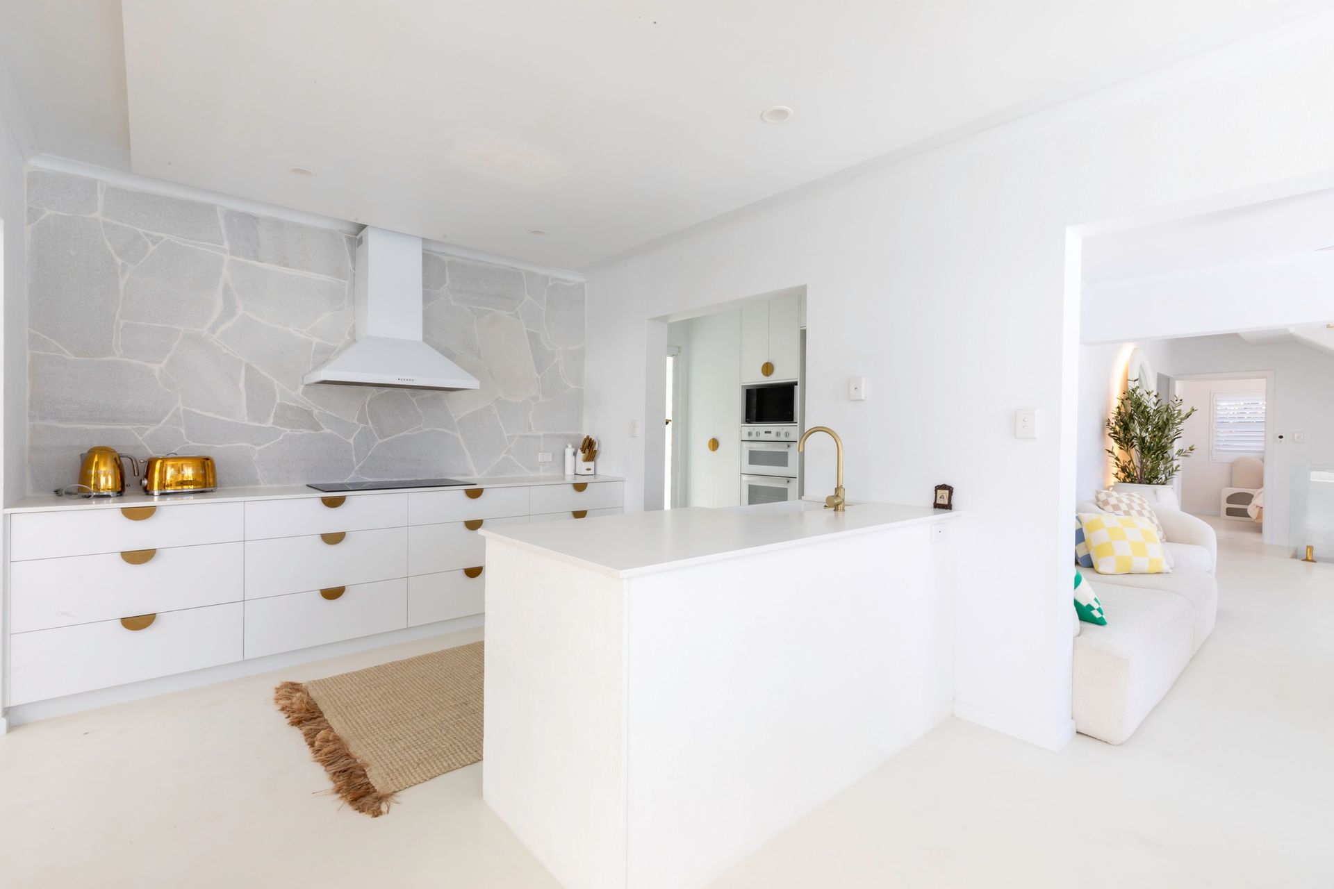 A Kitchen With Wooden Cabinets And A Ceiling Fan — Pioneer Cabinets in Paget, QLD