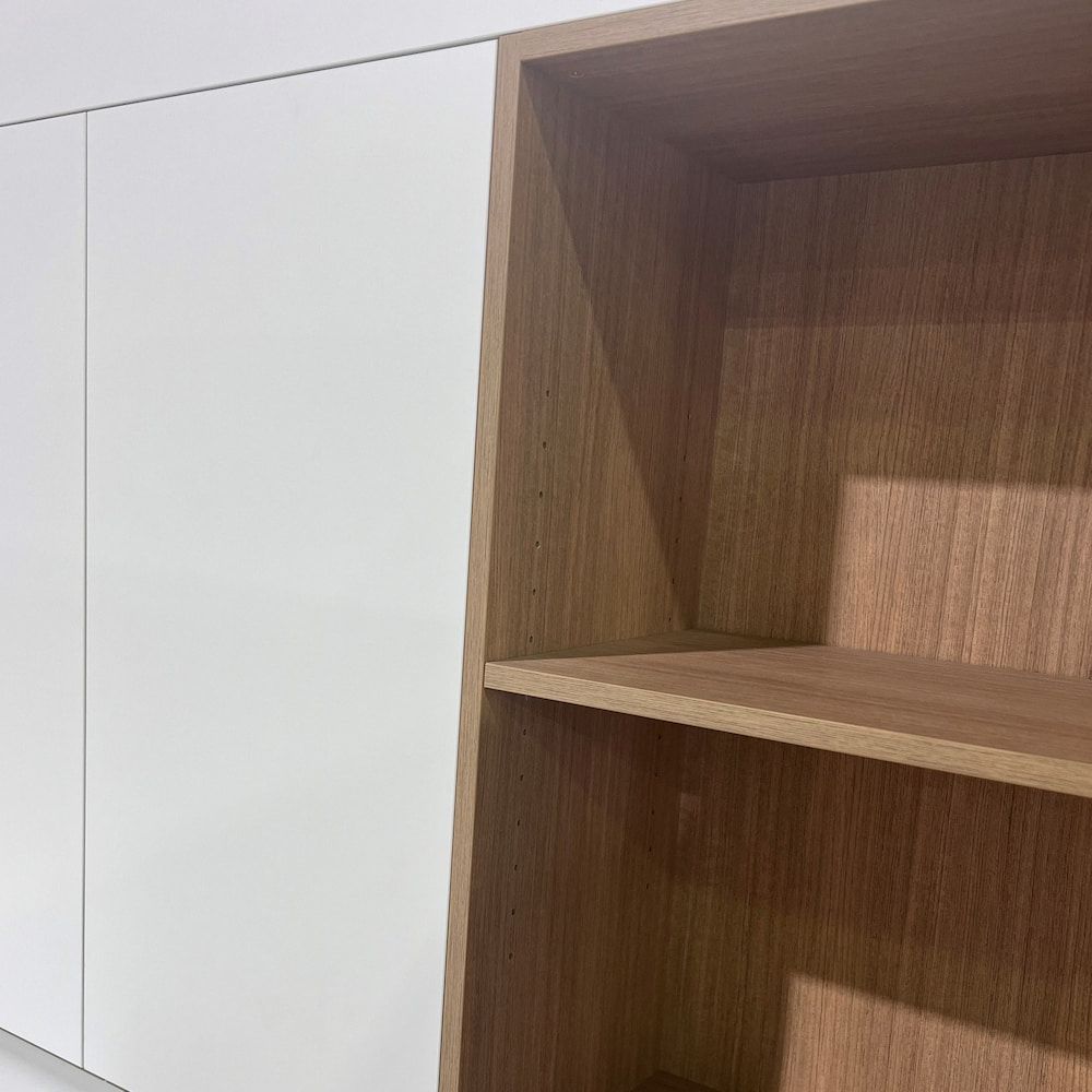 A Close Up Of A Wooden Shelf Next To A White Cabinet — Pioneer Cabinets in Rural View, QLD