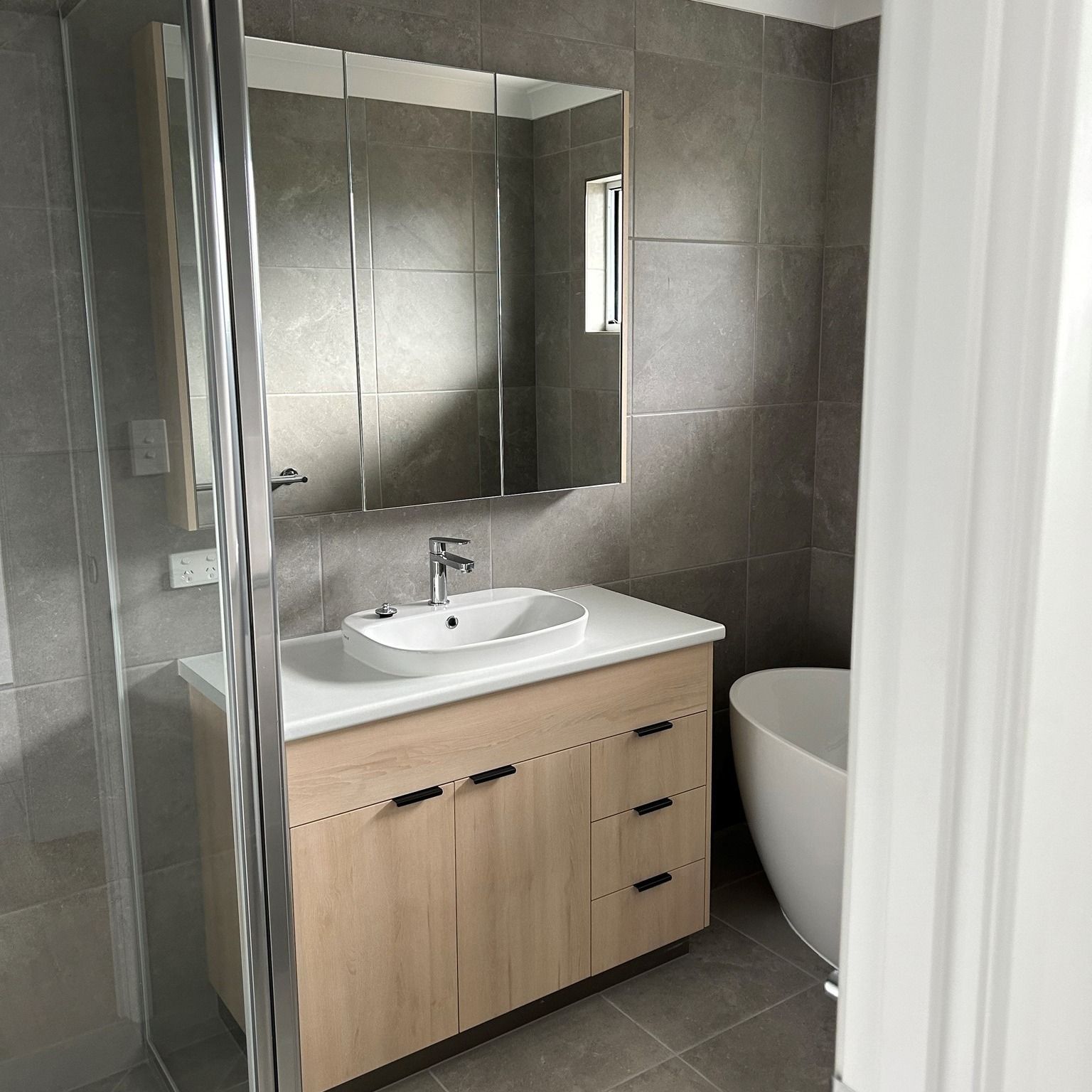 A Bathroom With Two Sinks And A Large Mirror — Pioneer Cabinets in Paget, QLD