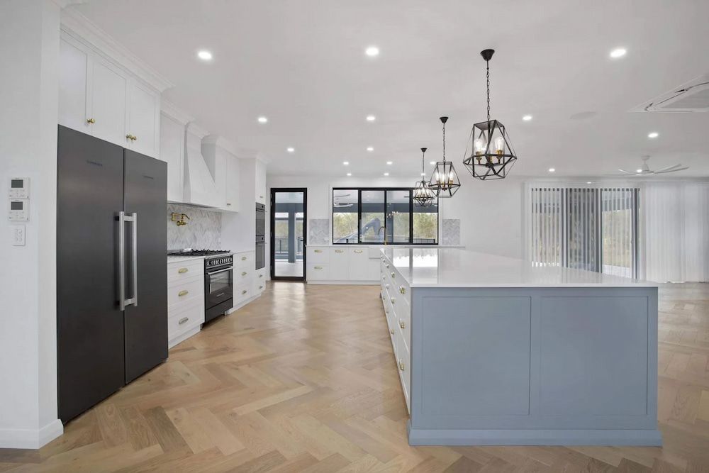 There Is A Large Island In The Middle Of The Kitchen — Pioneer Cabinets in Paget, QLD