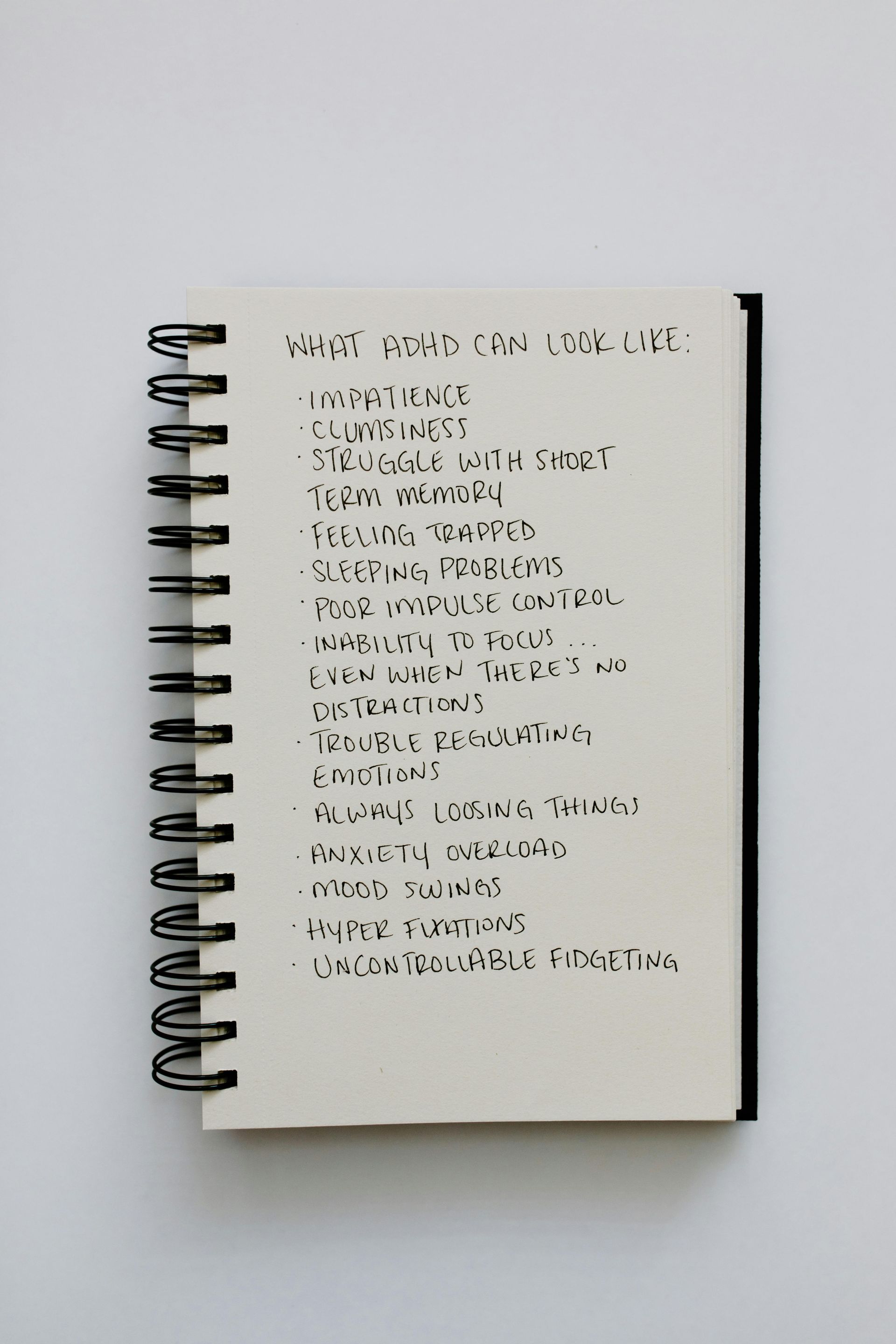 A spiral bound notebook with a list of words on it