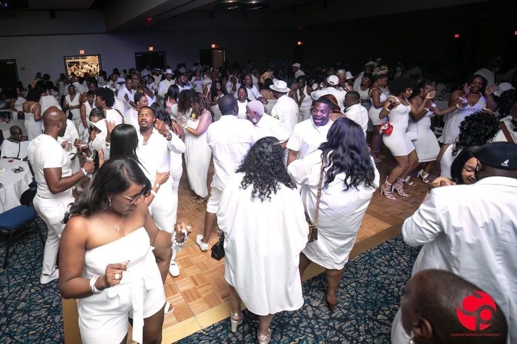 A large group of people are dancing in a room.