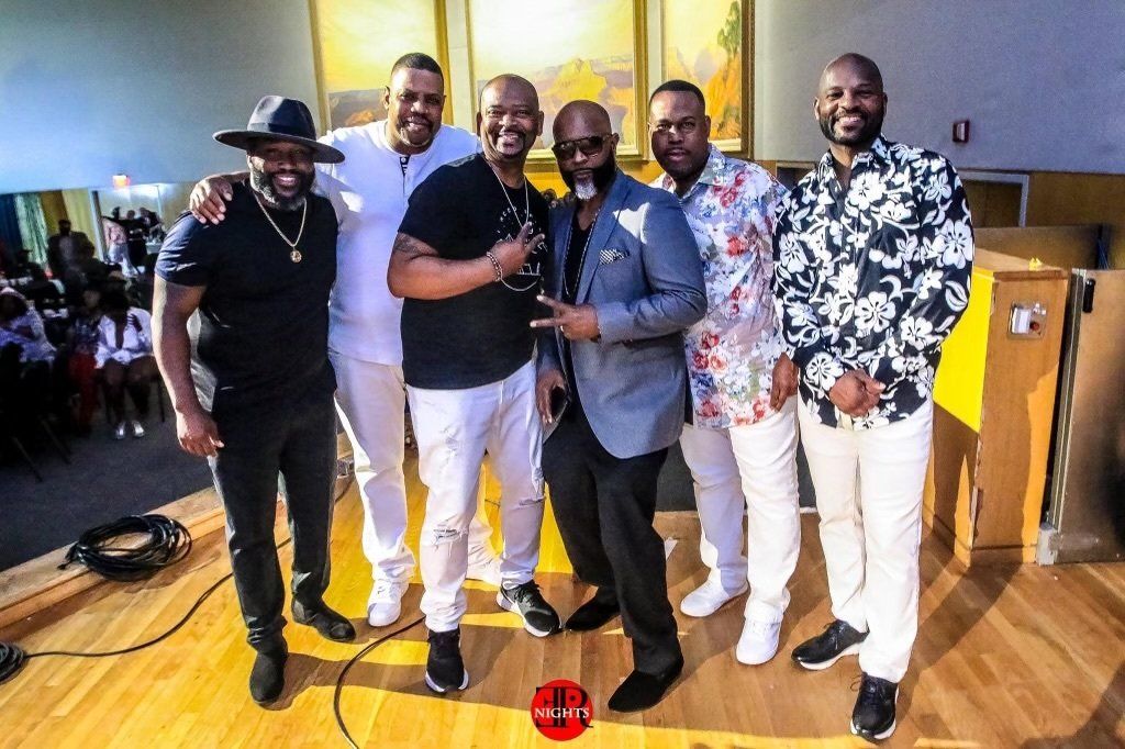 A group of men are posing for a picture together.