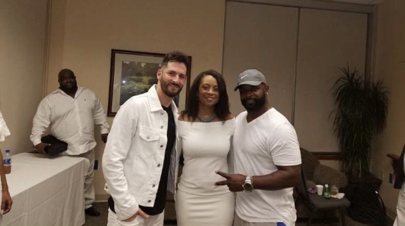 A group of people are posing for a picture in a room.