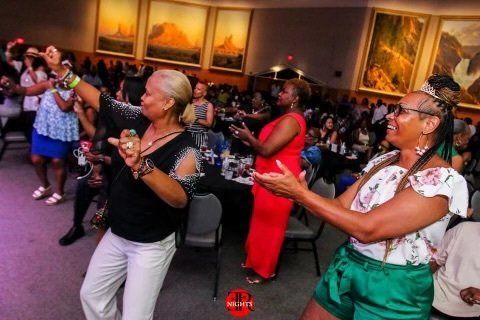A group of women are dancing in a room.