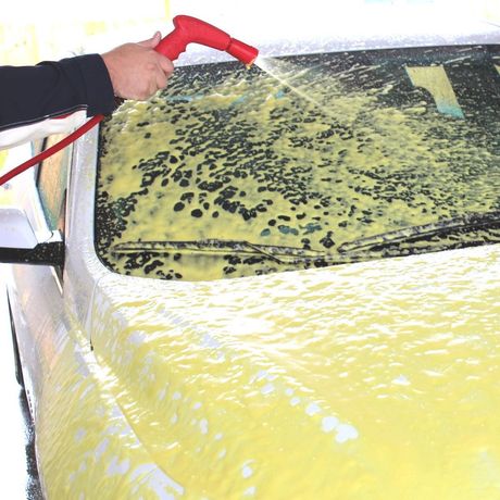 Self-Serve Car Wash Man washing car with pressure washer