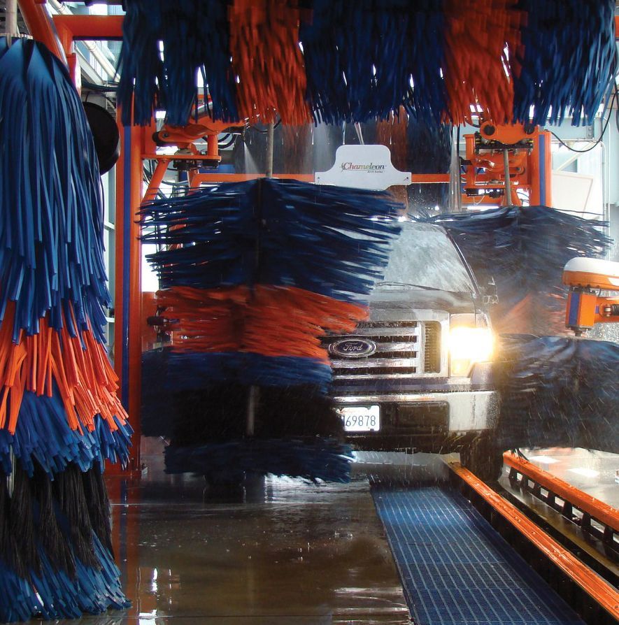 a car is going through a car wash with purple lights