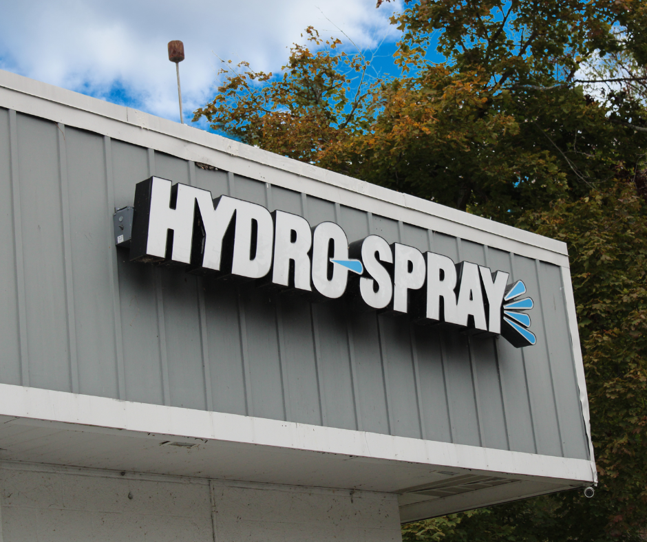 A sign on a building that says hydro spray
