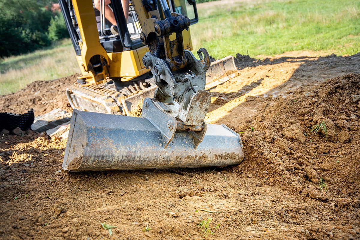 A bulldozer is digging a hole in the dirt.