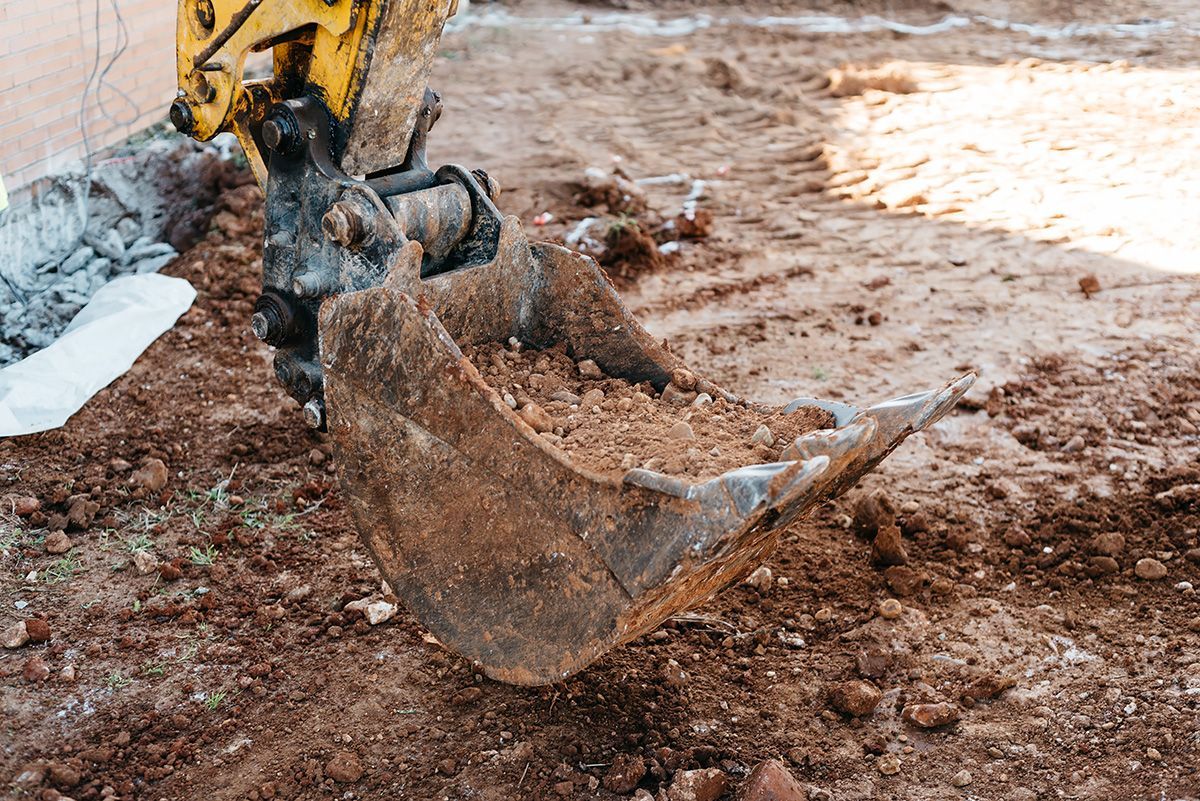 A bulldozer is digging a hole in the ground.