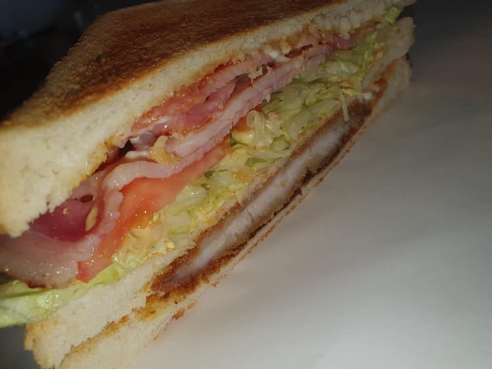 Club Sandwich with Layers of Lettuce, Tomato, Meat, and Toasted Bread — Mount Louisa Snack Bar in Mount Louisa, QLD