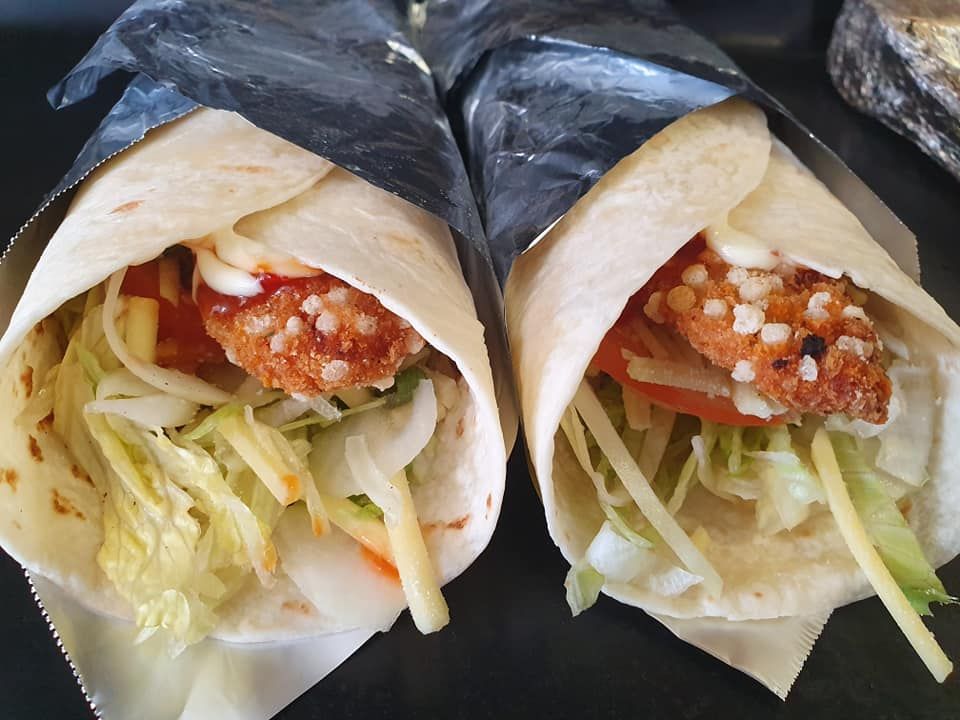 Two Wraps Filled with Chicken, Vegetables and Sauce — Mount Louisa Snack Bar in Mount Louisa, QLD
