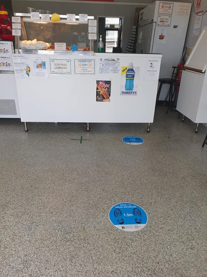 Counter with Social Distancing Floor Markers in A Shop — Mount Louisa Snack Bar in Mount Louisa, QLD