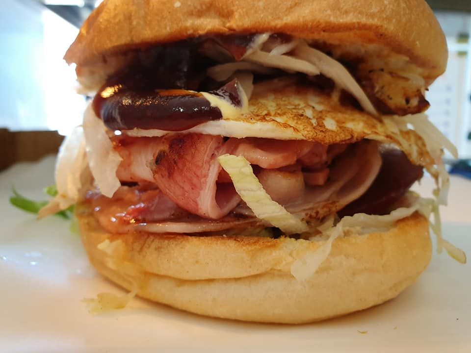 Burger with Bacon, Egg, Sauce and Shredded Cabbage — Mount Louisa Snack Bar in Mount Louisa, QLD